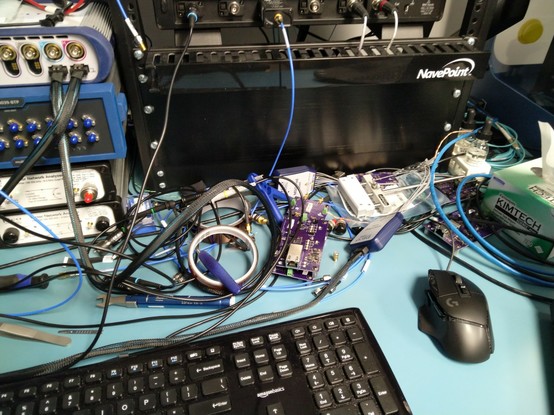 Pile of probes and cables with Ethernet fixtures and media converters poking out
