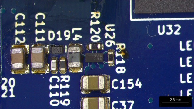 Microscope view of a bunch of SMT passives surrounding a tiny WLCSP BGA.

There's a small gap between the south side of the WLCSP and an 0805 capacitor with two filled vias that I need to get a passive soldered across.