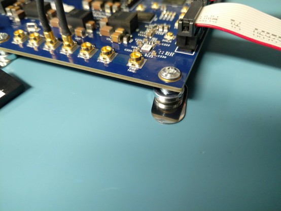 Closeup of magnetic standoff on steel plate sticker