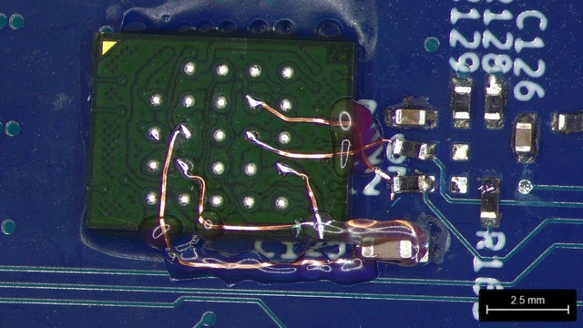 Flash underside halfway through rework with tiny copper wires taking shape between it and the footprint