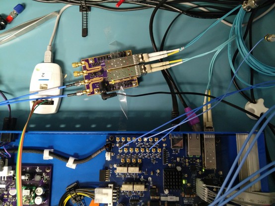 Mid span test fixture plugged between the SFP+ port on the back of the trigger crossbar and the long coil of fiber going to the switch port