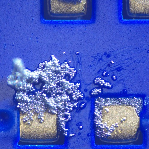 0402 passive footprint with solder paste smeared off it, probably by a careless finger tip
