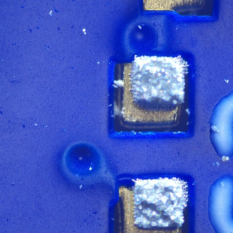 0402 SMT footprint with the paste print displaced slightly northeast of center