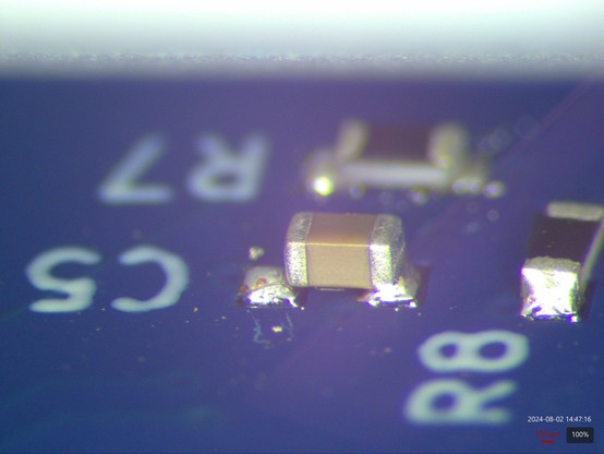 Ceramic capacitor with good wetting on one side, but the other side sitting on top of a blob of solder without making good contact