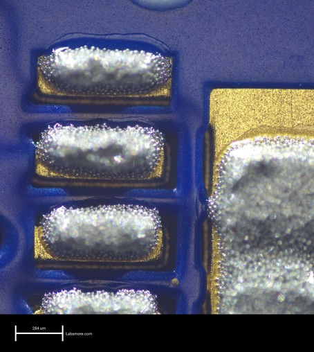 Solder paste deposits on a smaller DFN component, showing near-perfect alignment