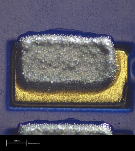 Solder paste deposits on a large component pad showing about 150um of north registration error