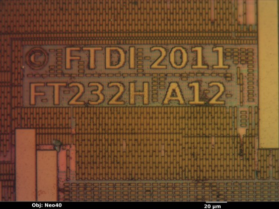 Microscope photo of an IC die showing UMC's 180nm PDK fill pattern and the text "(C) FTDI 2011 / FT232H A12"