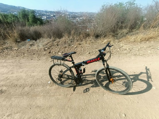 a photo of my folding and full suspension bike at the middle of a hill.