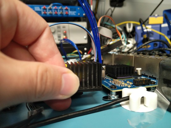 Me holding a heatsink next to a PCB showing that it's about twice the size of the one currently installed