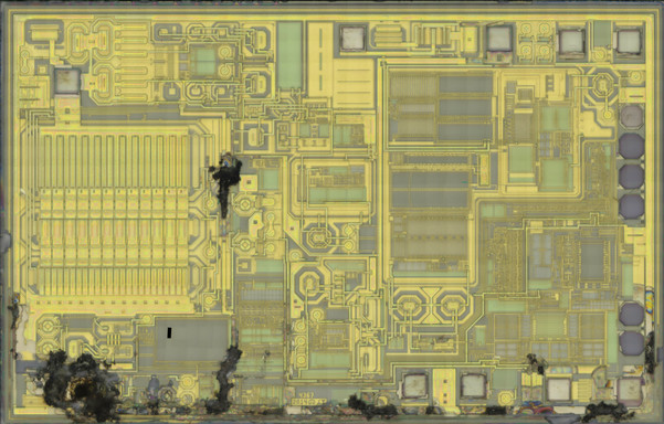 2-metal IC die with obvious catastrophic damage in several spots