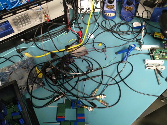Lab bench covered in cables, velcro pieces, and probes