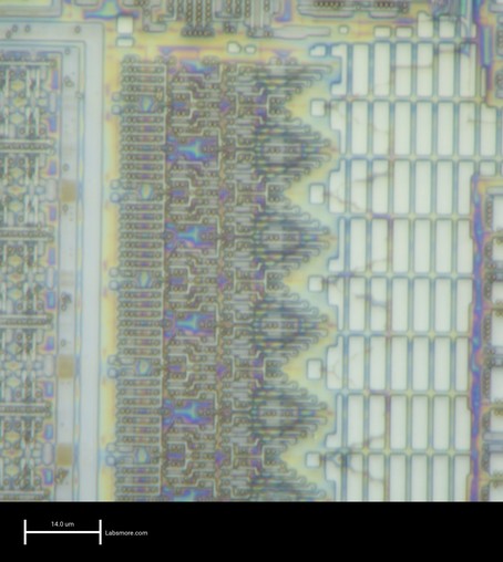 SRAM address decode circuitry showing poly and oxide over substrate, with colorful interference fringes in incompletely etched areas