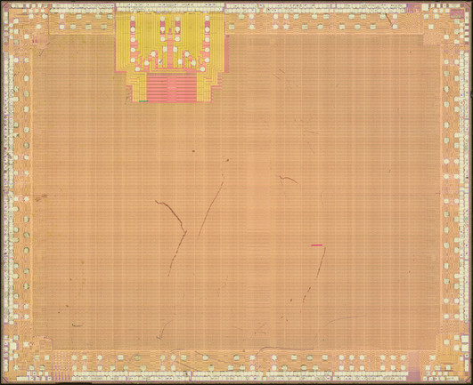 Top metal image of an FPGA. Not a whole lot visible since the whole die is covered in power/ground grid, except for the GTP SERDES block in the top just left of center
