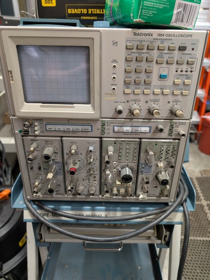 Front panel of a Tek 7854 oscilloscope. Very early digitizing scope with CRT and mostly analog dial controls but can still do measurements and has GPIB