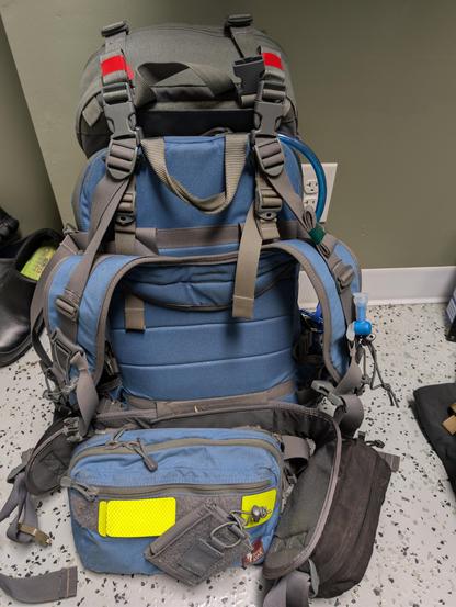 Blue backpack and chest pack with gray trim and yellow reflective panels on the front