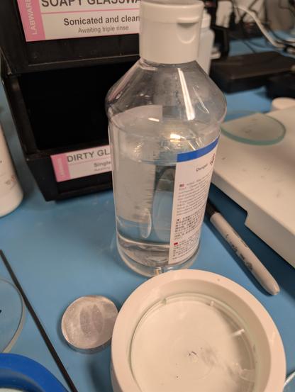 Bottle of clear liquid on a lab bench