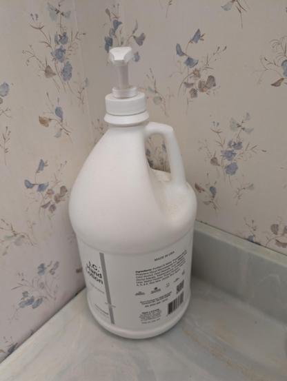 Gallon jug of IC Hand Lotion on a bathroom counter