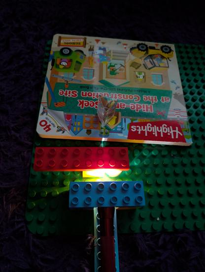 Overview of the new spectrometer setup: a mag lite sits in the groove between two studs with bricks on either side to keep it from rolling, then has a single stud gap before the slit for inserting the sample into